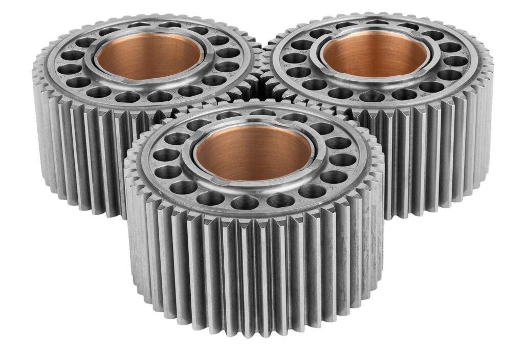 Three precision gears with copper-colored inner rings on white