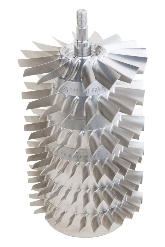 Vertical stack of metal turbine rotors on white