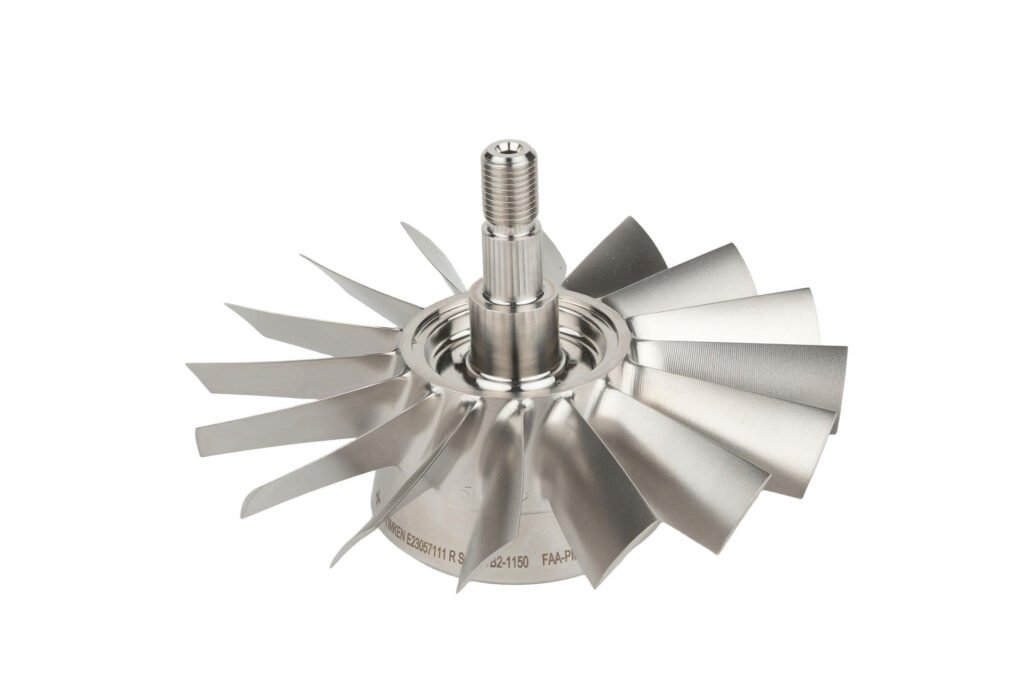 Metal impeller with curved blades photographed at an angle