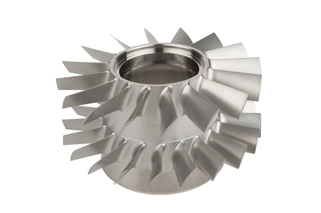 Stacked metal impellers photographed against white