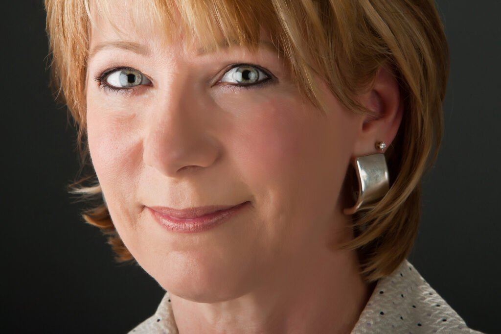 Close-up portrait of a woman with short auburn hair