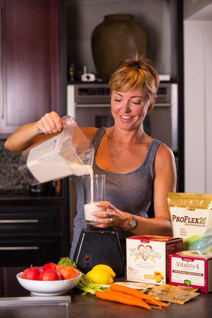 Woman preparing a nutrition drink in a kitchen