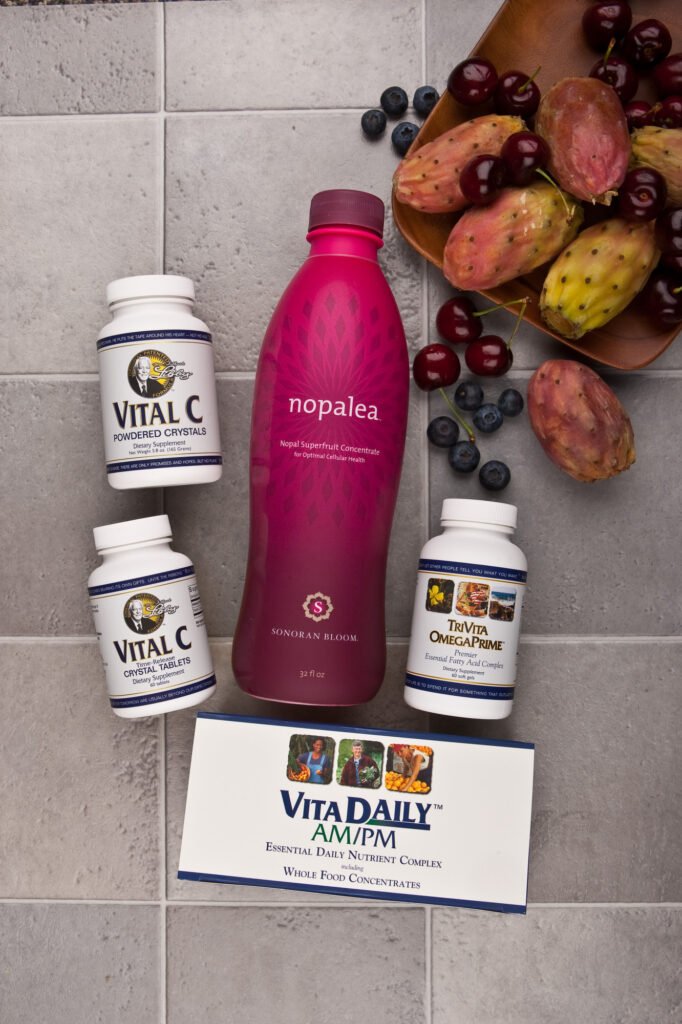 Nutritional supplement bottles arranged beside fresh fruit