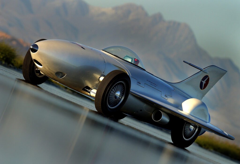 Silver sports car photographed in motion