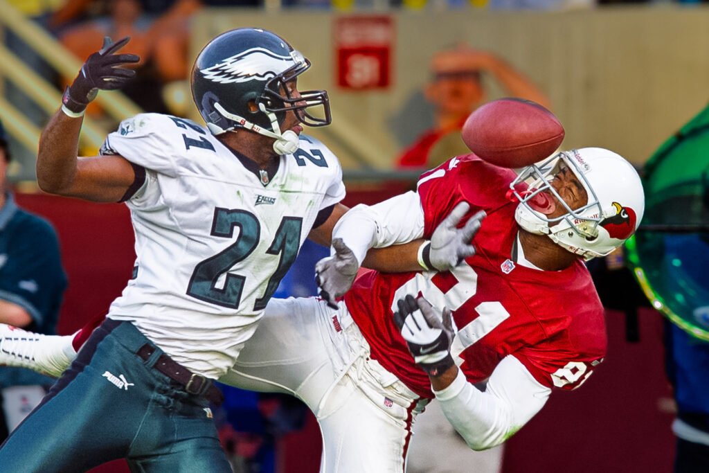 Football players competing for a pass during a game