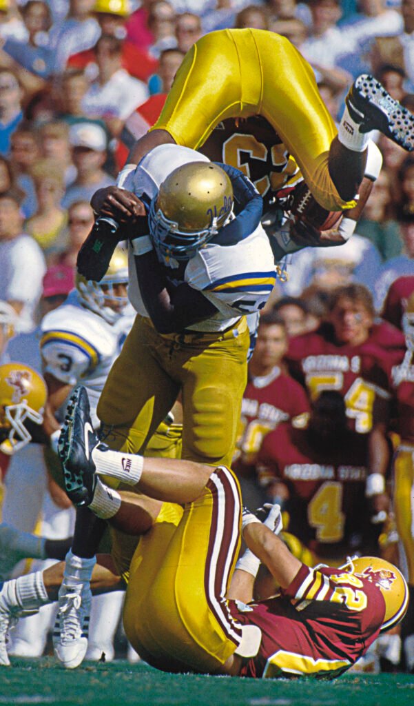 Football players colliding during a tackle