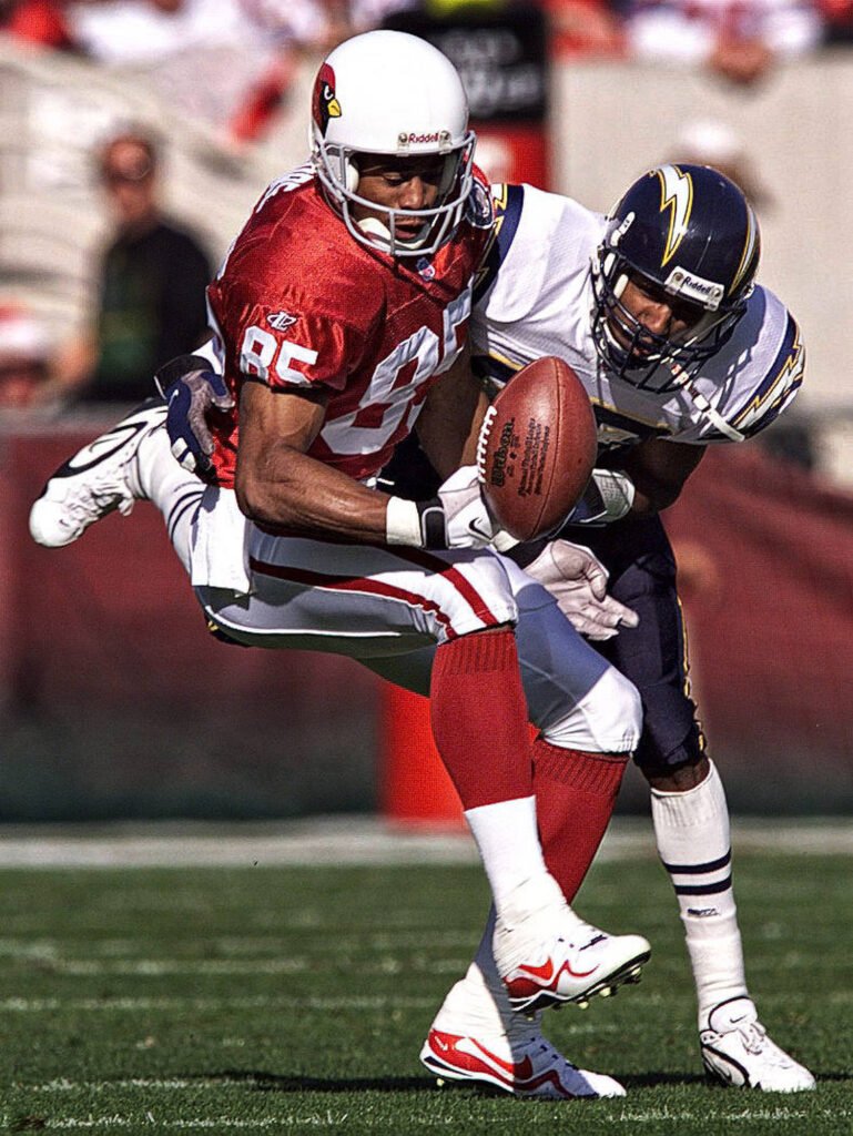 Football receiver tackled while holding the ball