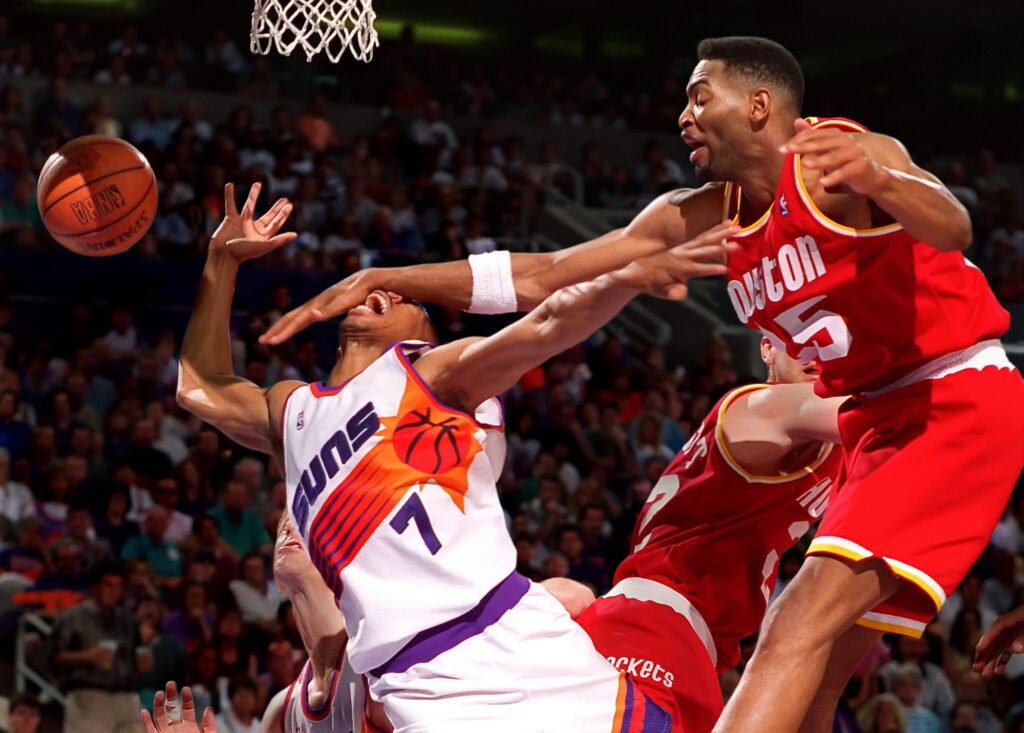 Basketball players contesting the ball during a game