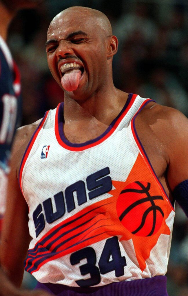 Basketball player in a Suns number 34 jersey reacting during a game