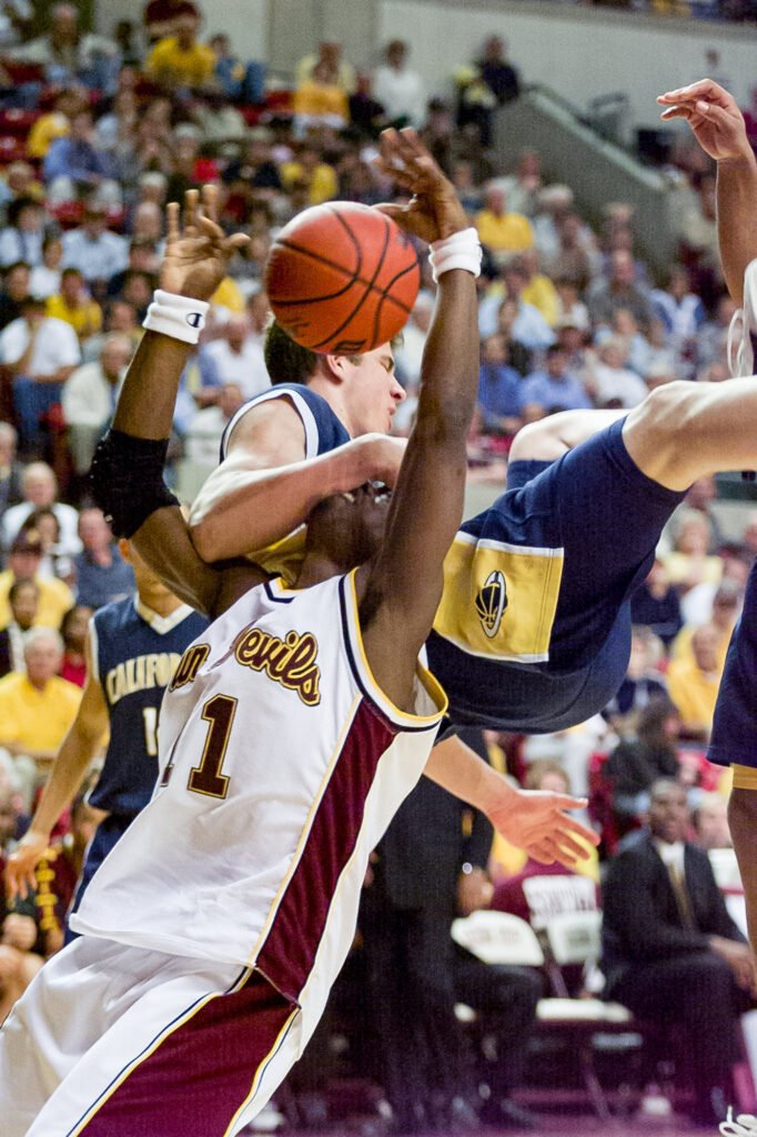 Basketball player taking a shot between defenders