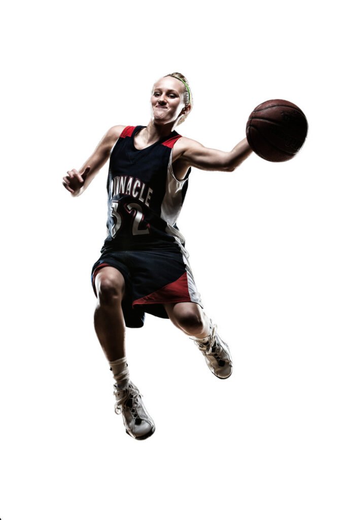 Basketball player reaching forward with a ball against white