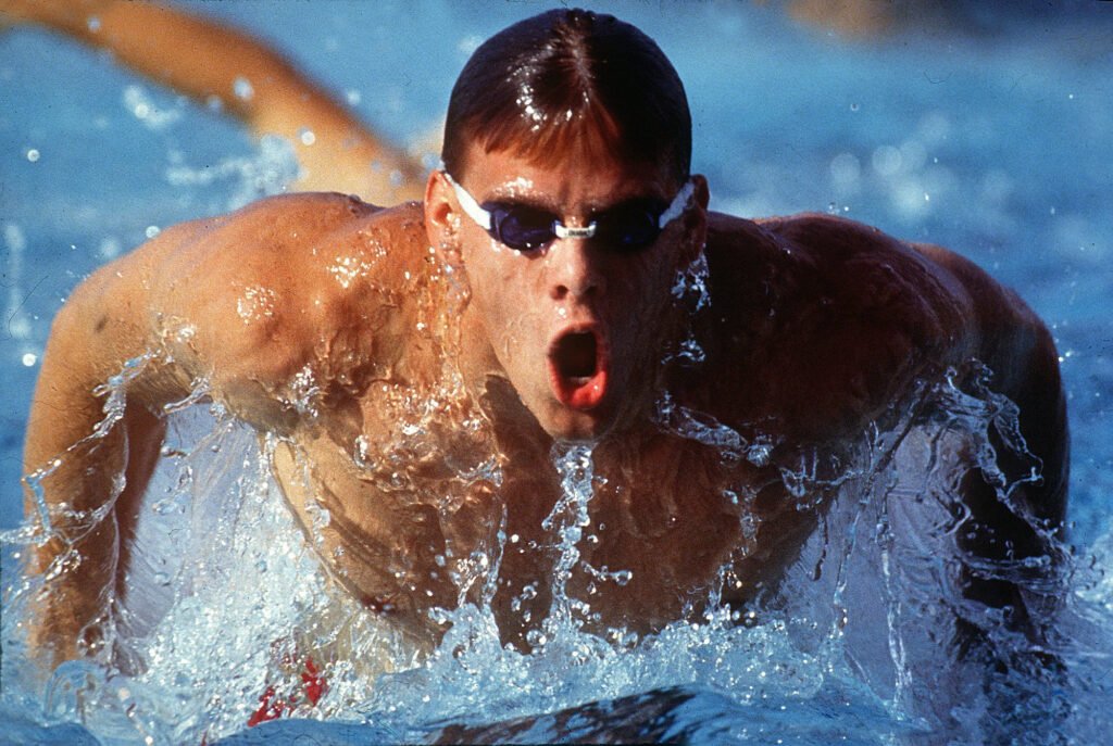 Swimmer rising out of the water during a race