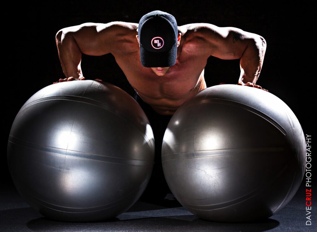 Athlete doing a push-up between two exercise balls